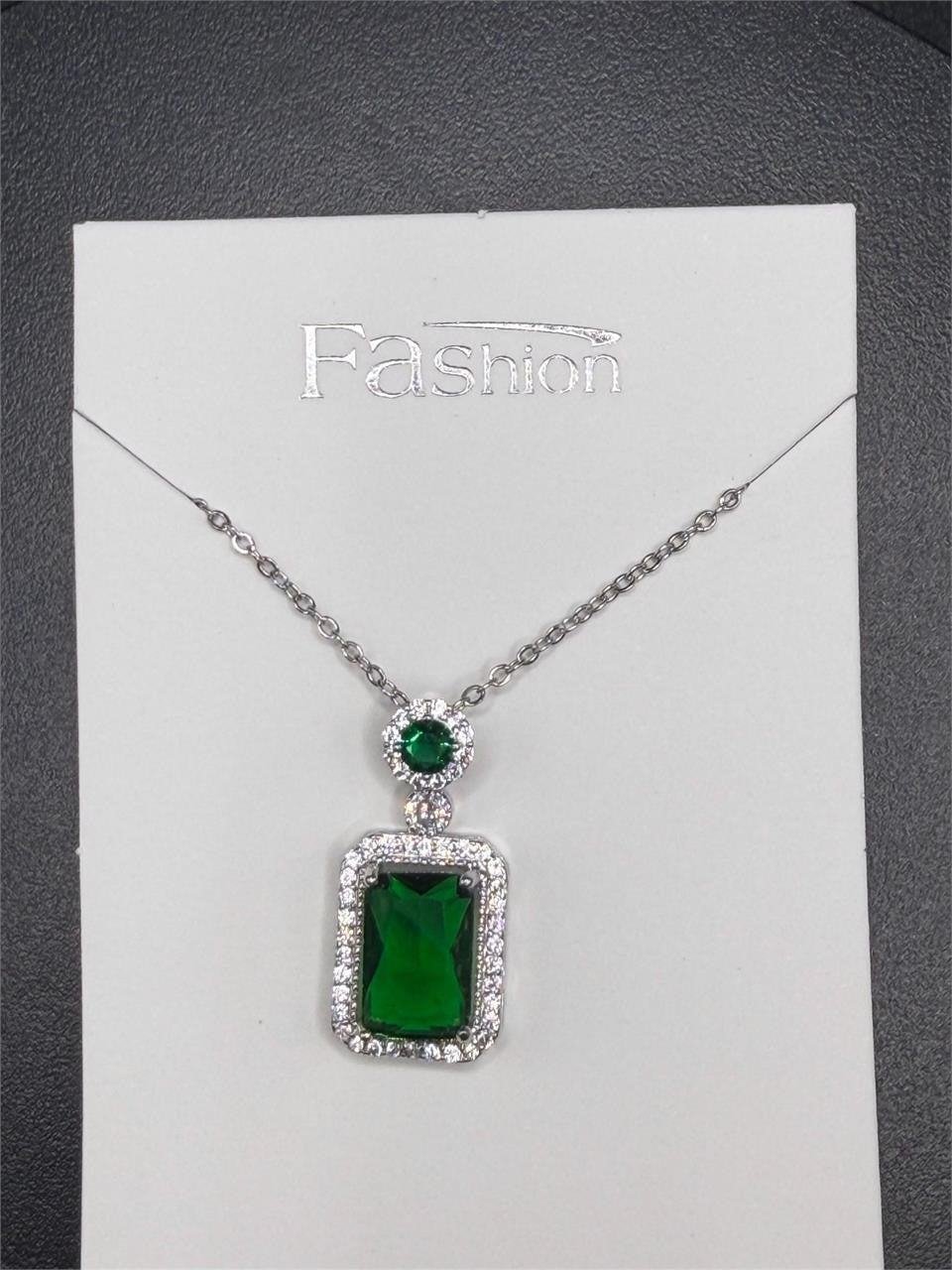 Emerald style crystal pendant necklace from Republic Mercantile featuring a sparkling green gemstone on a silver chain