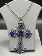 Large blue crucifix pendant necklace on silver chain by Republic Mercantile, featuring a detailed cross design with a vibrant blue centerpiece.