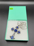 Large blue on silver crucifix pendant necklace featuring a detailed crucifix design on a silver chain.