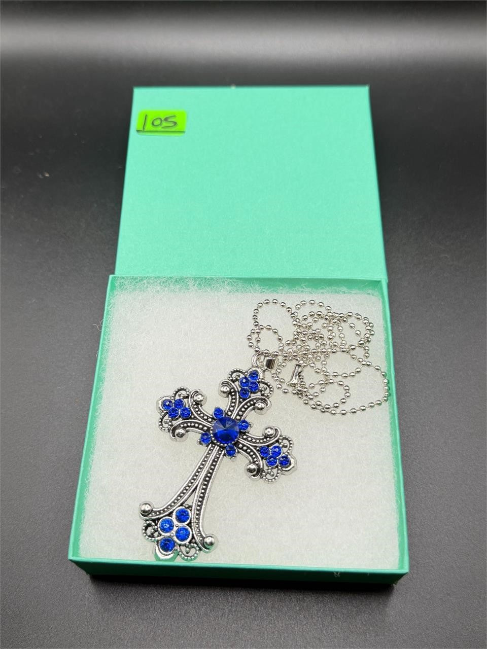 Large blue on silver crucifix pendant necklace featuring a detailed crucifix design on a silver chain.