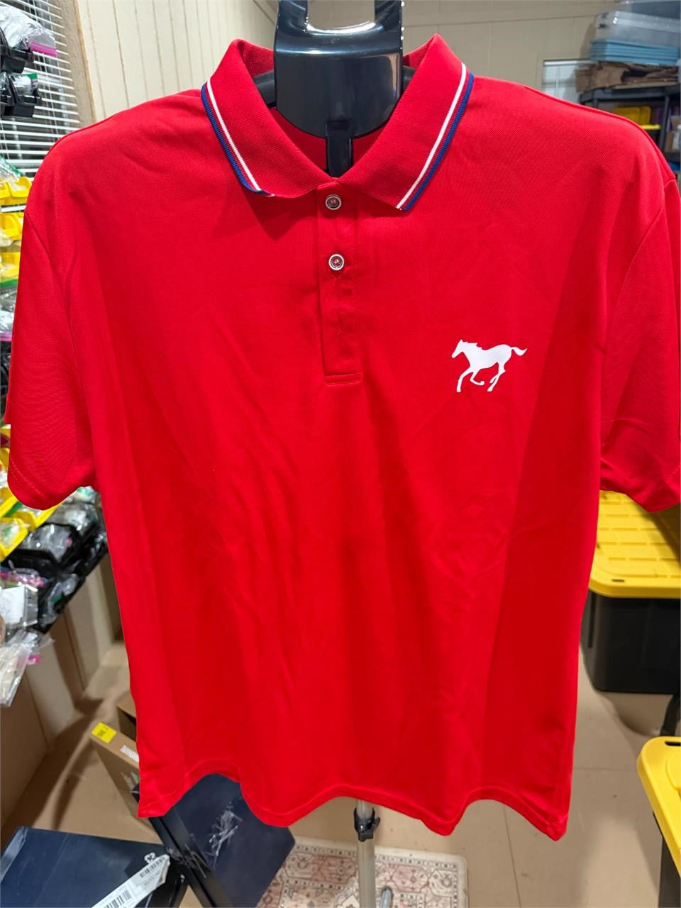 Men's red polo shirt by Republic Mercantile, size XL, displayed on a hanger with collar and short sleeves visible.