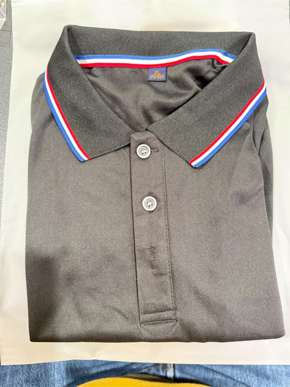 Men's black polo shirt in size XL from Republic Mercantile, displayed flat showing collar and short sleeves.