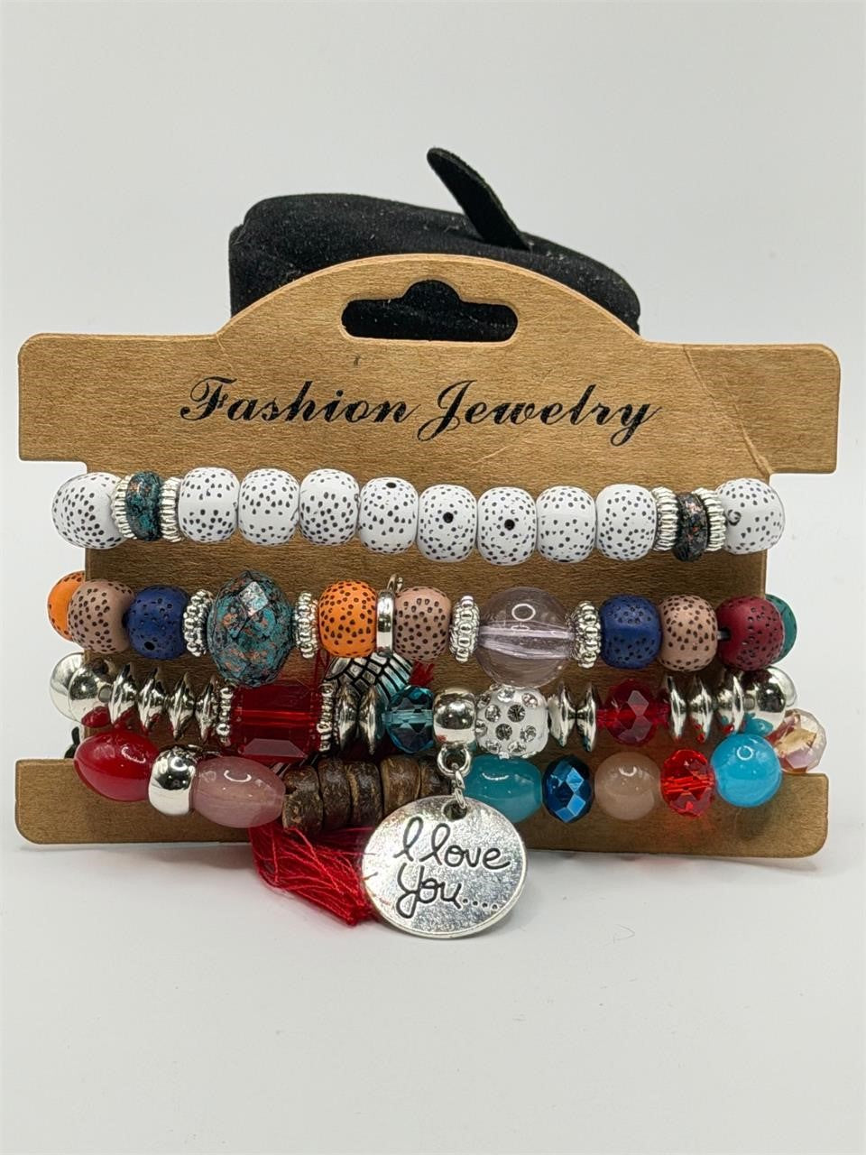 Handcrafted 4 strand boho beaded charm bracelet with colorful beads and metal charms by Republic Mercantile.