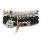 Handcrafted 4 strand boho beaded charm bracelet with colorful beads and metal charms, created by Republic Mercantile.