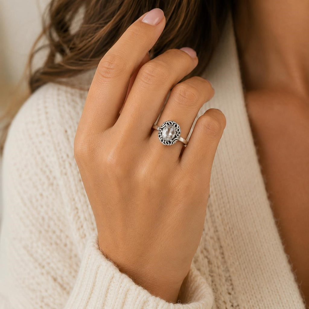 Ladies .925 sterling silver oval crystal ring with clear faceted gemstone in size 6.5, featuring a polished silver band.
