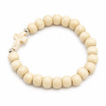 White beaded bracelet with a cross charm, stylish jewelry piece by Republic Mercantile, shown on a neutral background.