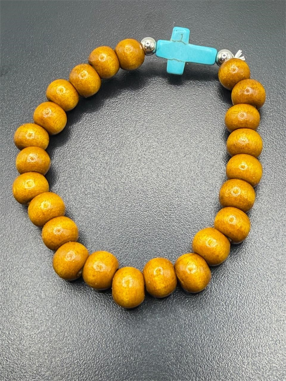 Beaded bracelet with beige and blue beads featuring a cross pendant, handmade jewelry by Republic Mercantile.