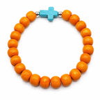 Beaded bracelet with orange and blue beads featuring a cross pendant, from Republic Mercantile.