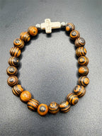 Beaded bracelet with tiger wood beads and white cross charm, stylish jewelry accessory from Republic Mercantile.
