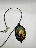 Black Virgin Mary pendant necklace with rope chain from Republic Mercantile, showcasing religious jewelry on a neutral background.