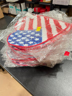 Wholesale 25-pack of 16-inch Republic Mercantile non-slip flag-themed rugs, showing colorful designs and textured surfaces.