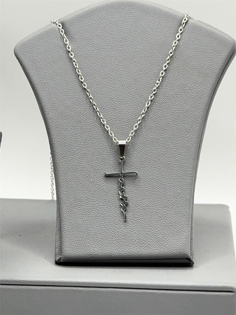 Christian-themed stainless steel necklace with faith pendant, featuring religious symbols on a sleek chain.