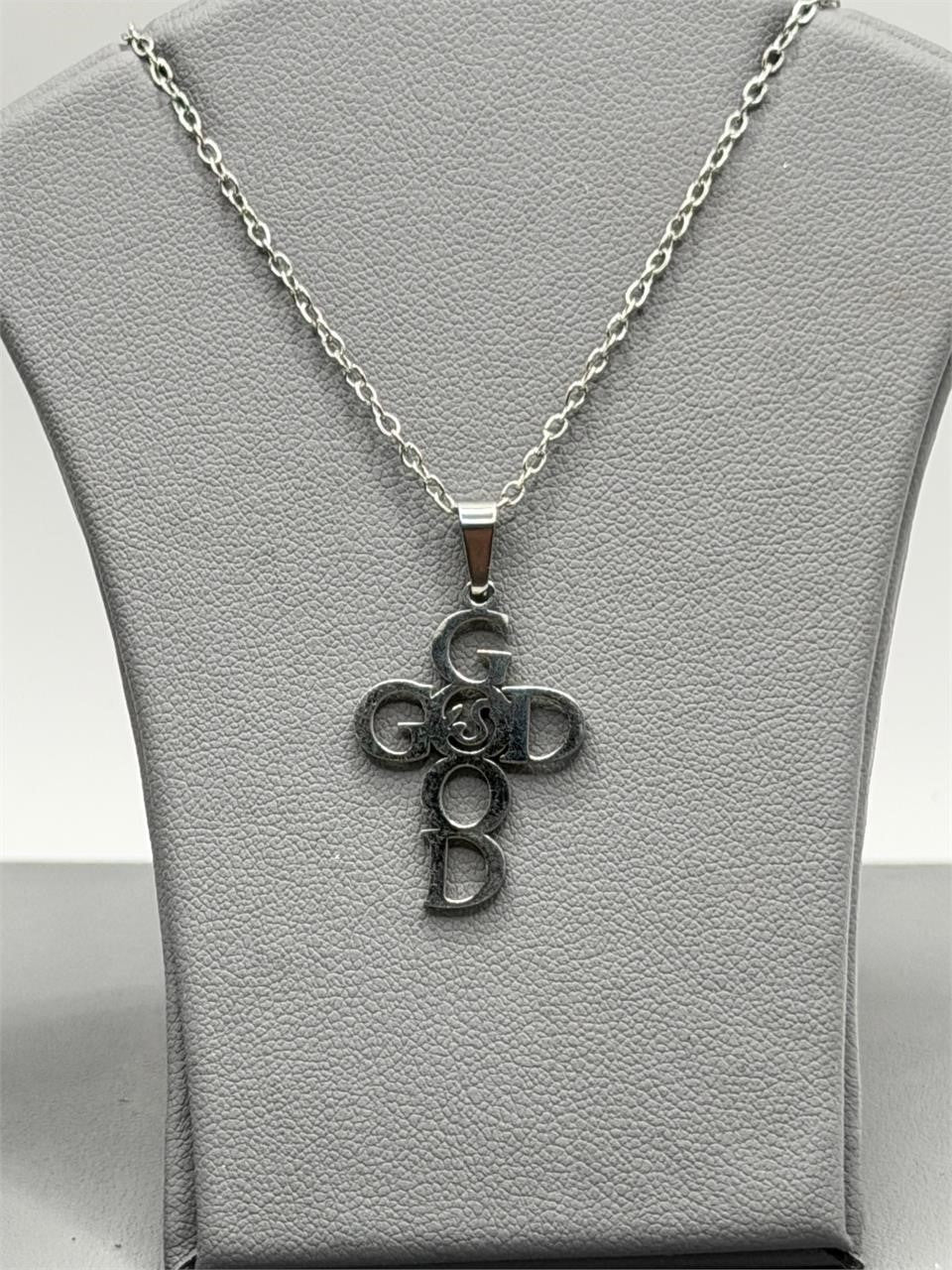 Christian-themed stainless steel necklace with "GOD" pendant, featuring a sleek design and polished finish.