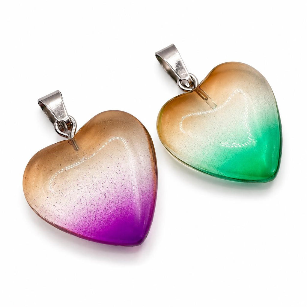 Two heart-shaped glass pendants from Republic Mercantile, clear and reflective, hanging side by side.