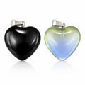 Two heart-shaped glass pendants with silver chains, crafted by Republic Mercantile, hanging side by side.