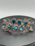 Ornate blue floral hair barrette with intricate metalwork and decorative design, perfect for elegant hair styling.