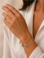 Handmade golden charm bracelet with intricate details from Divine Designs, featuring multiple charms and elegant design.
