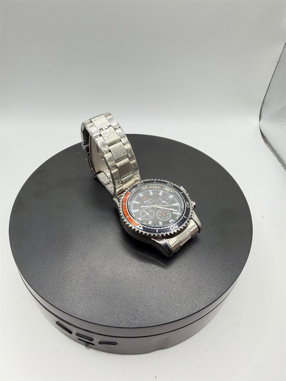 Men's Hkun black dial watch with silver case and band by Republic Mercantile, showing a close-up of the stylish timepiece.