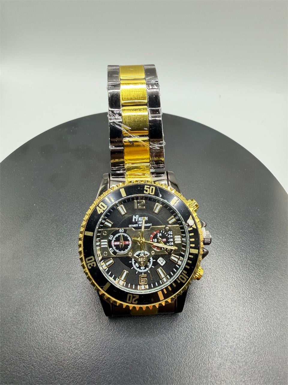 Men's Hkun black and gold case and band watch by Republic Mercantile showing the stylish timepiece with a sleek design.