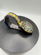 Men's Hkun black and gold case and band watch by Republic Mercantile, showing close-up of sleek design and detailed watch face.