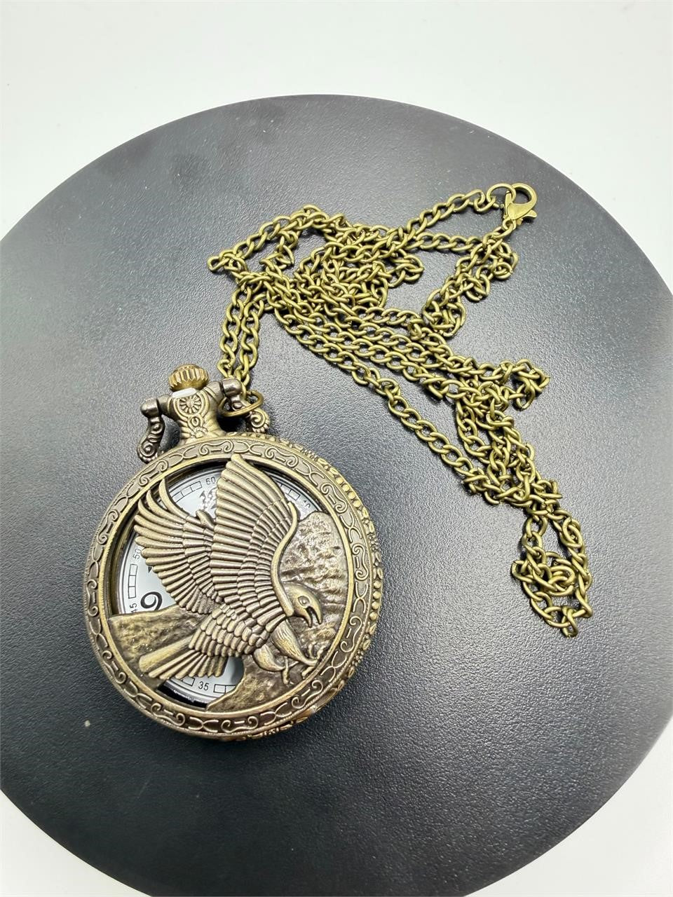 Silver man's pocket watch with chain featuring an eagle design, classic timepiece by Republic Mercantile.
