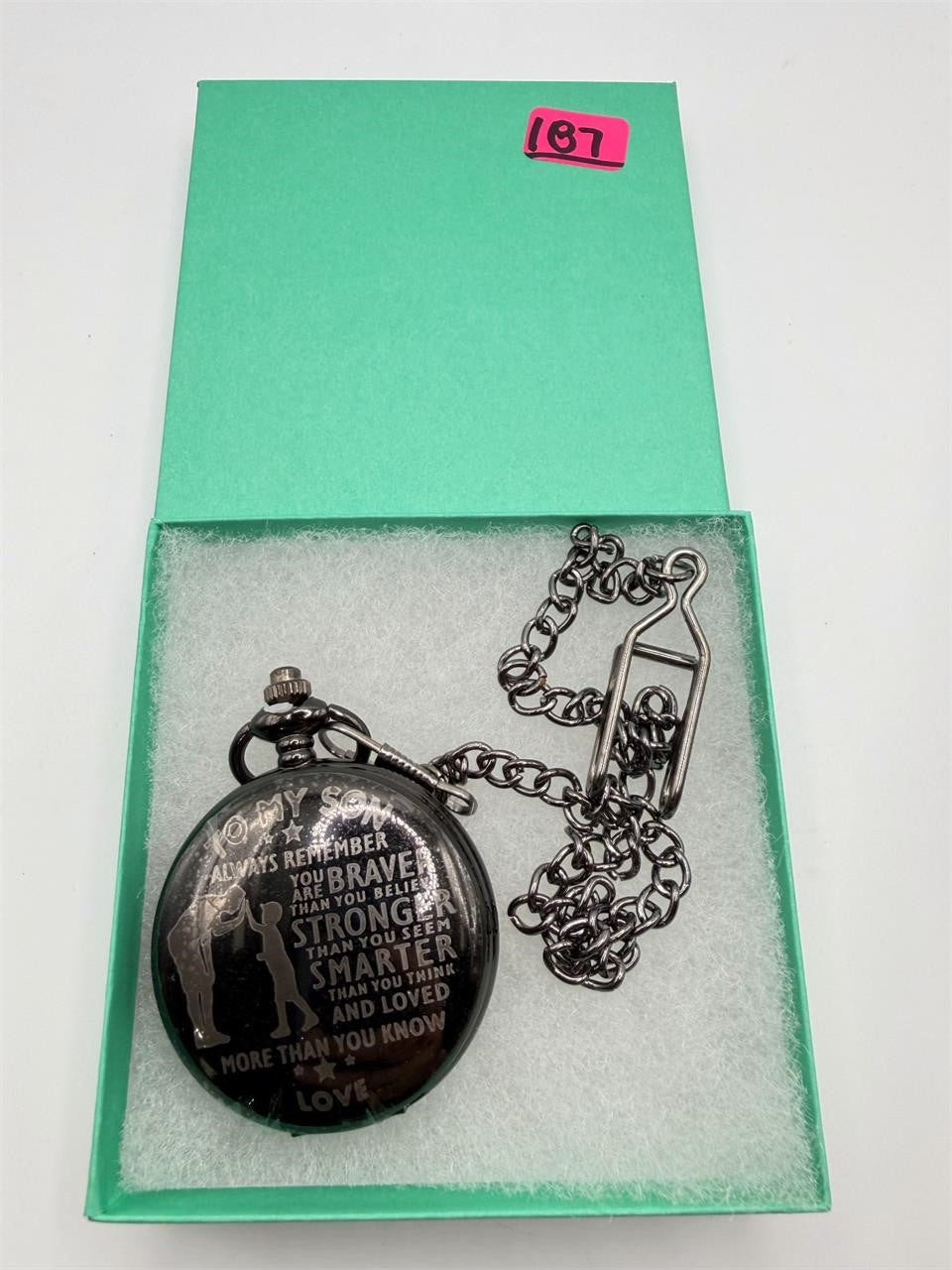 Silver man's pocket watch with chain from Republic Mercantile, engraved with "To My Son" on the cover.