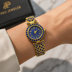 Women's gemstone watch in blue on gold band, featuring a round face with gemstone accents, by Republic Mercantile.