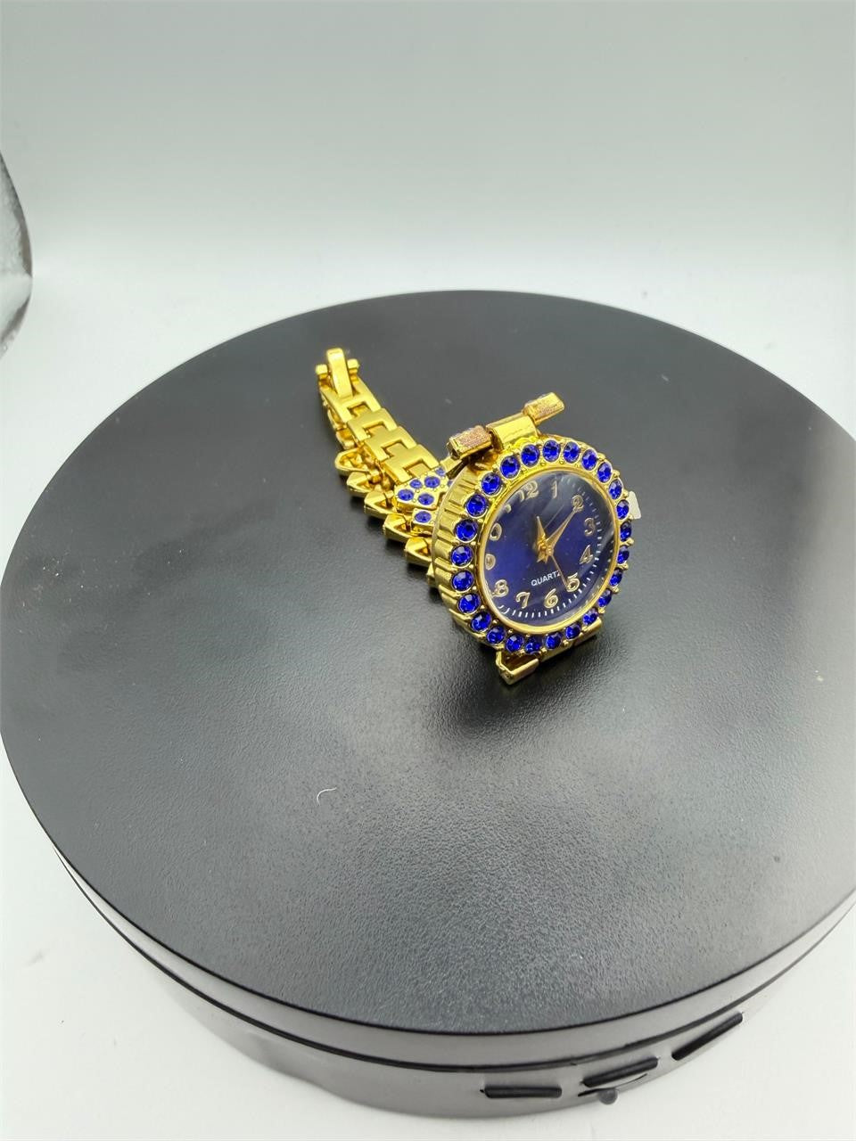 Women's gemstone watch in blue on gold with a sleek round face and elegant bracelet from Republic Mercantile.
