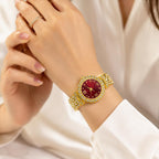 Women's gemstone watch with red face on gold band from Republic Mercantile, showcasing elegant jewelry design.