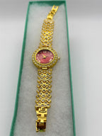 Women's gemstone watch with red dial on gold-tone band by Republic Mercantile, showcasing elegant jewelry timepiece design.