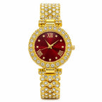 Women's gemstone watch with a red face and gold band by Republic Mercantile, showcasing elegant jewelry design.