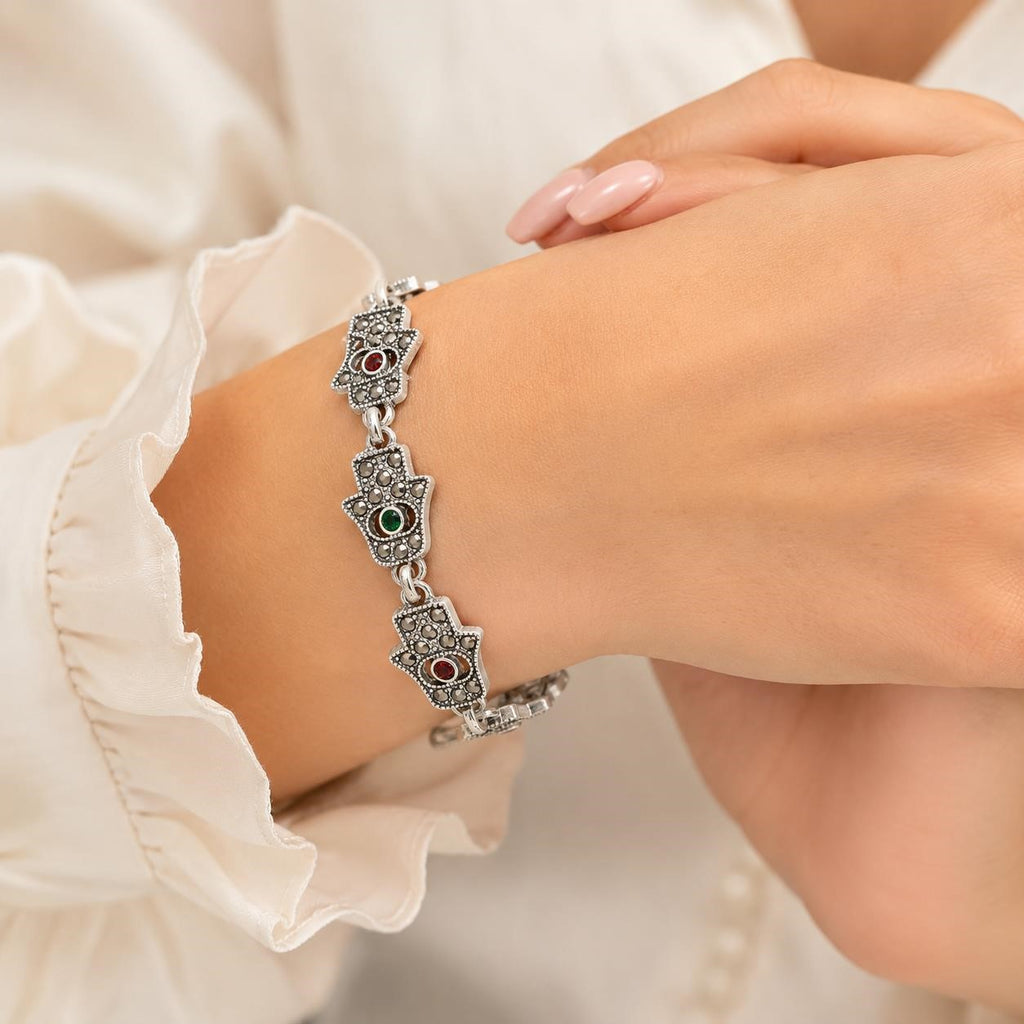 Women's Hamsa hand-link bracelet with marcasite-style accents, featuring intricate design and silver-tone metal details.