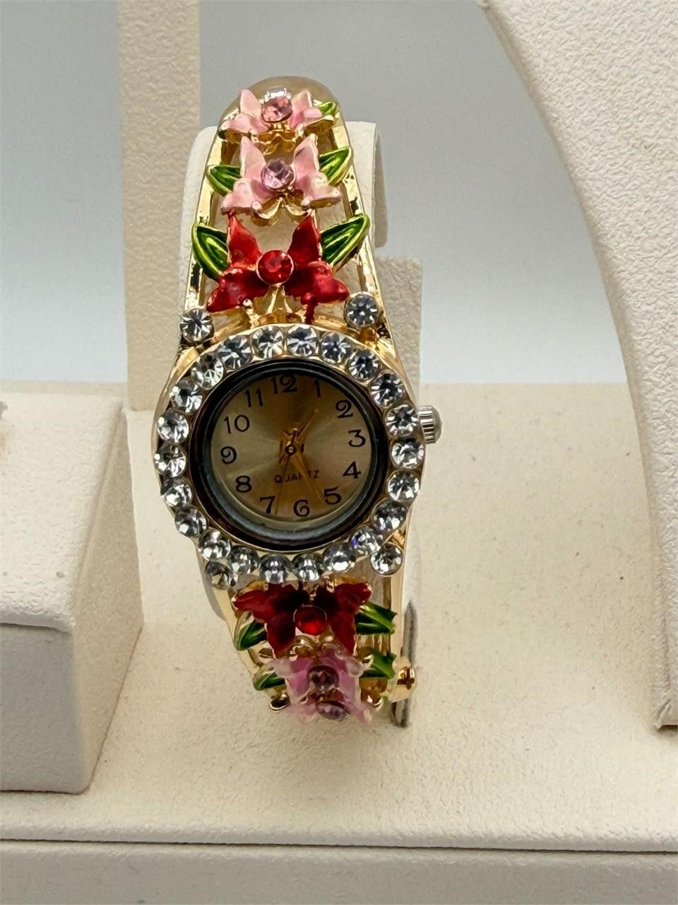 Republic Mercantile enamel flower cuff watch with floral design and rhinestones, showcasing a decorative wrist accessory.