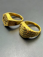 Pair of men's gold tone rings in size 10 from Republic Mercantile, showcasing stylish jewelry with polished finish.