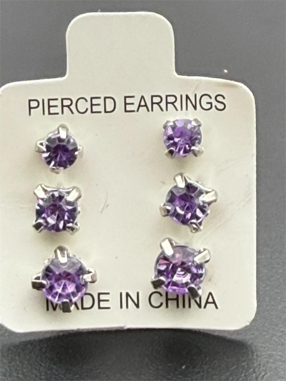 Set of three Republic Mercantile purple crystal gem earrings in small, medium, and large sizes with sparkling purple stones.