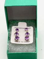 Set of three crystal purple gem earrings in small, medium, and large sizes, featuring silver hooks, by Republic Mercantile.