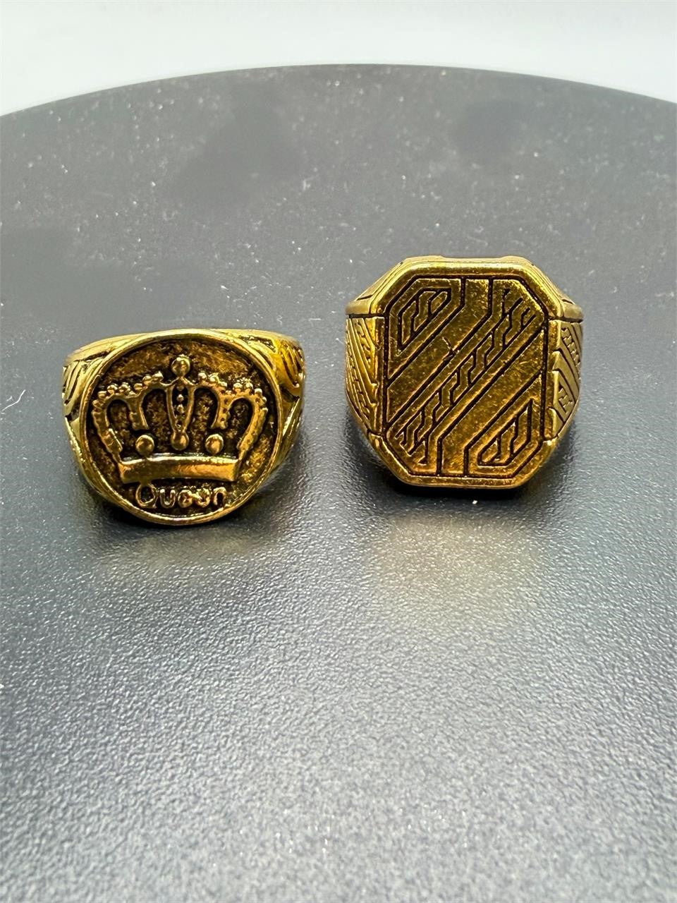 Pair of gold tone men's rings in size 7.5 from Republic Mercantile, featuring sleek band designs and polished finishes.