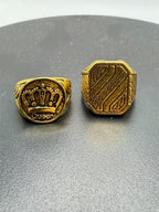 Pair of gold tone men's rings in size 7.5 from Republic Mercantile, featuring sleek band designs and polished finishes.