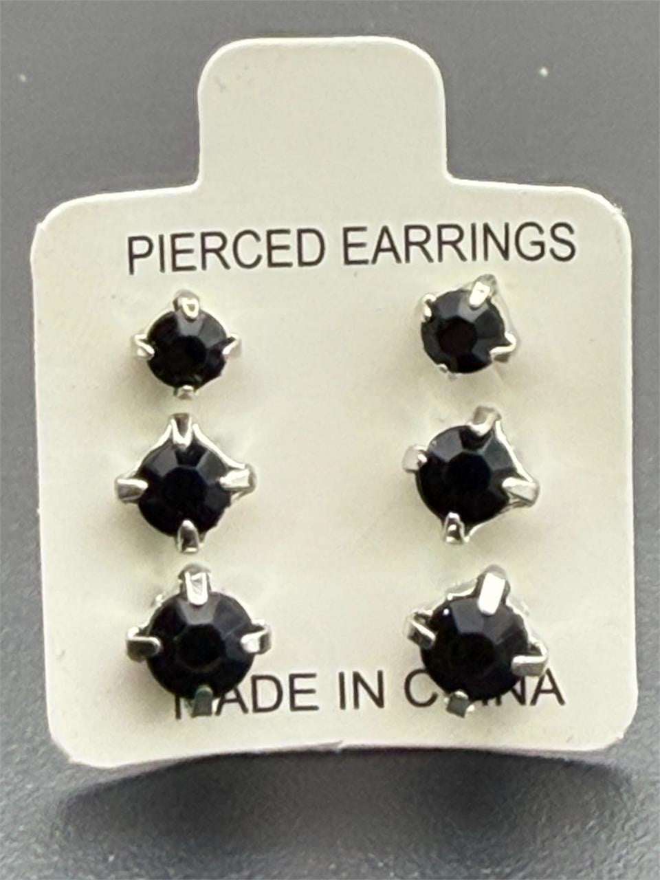Three pairs of black crystal gem earrings in small, medium, and large sizes from Republic Mercantile displayed on a white background.