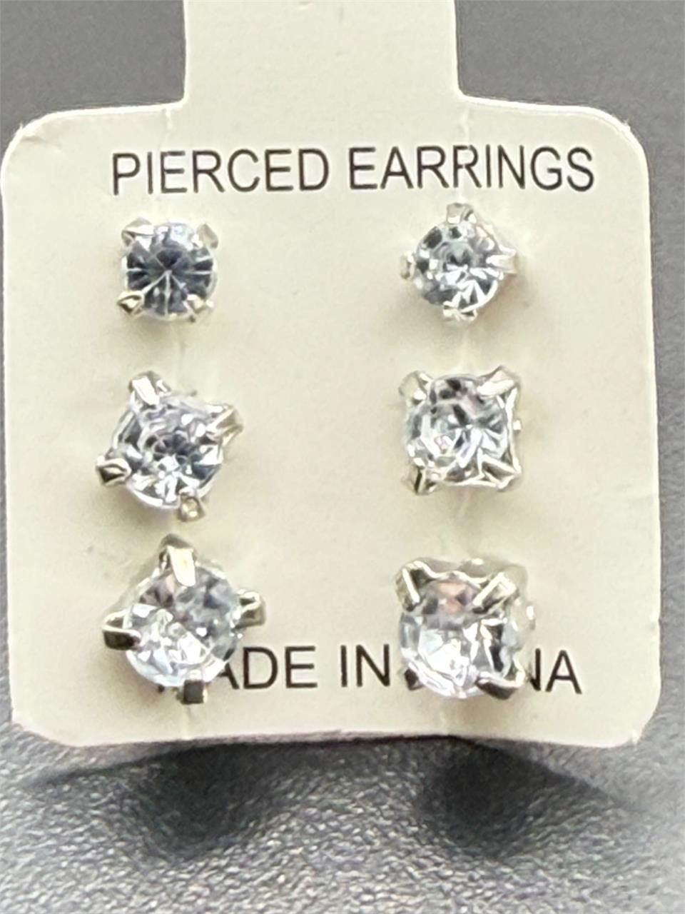 Three pairs of Republic Mercantile crystal clear gem earrings in small, medium, and large sizes displayed together.