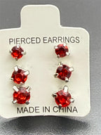 Three pairs of red crystal gem earrings in small, medium, and large sizes from Republic Mercantile displayed on a white background.