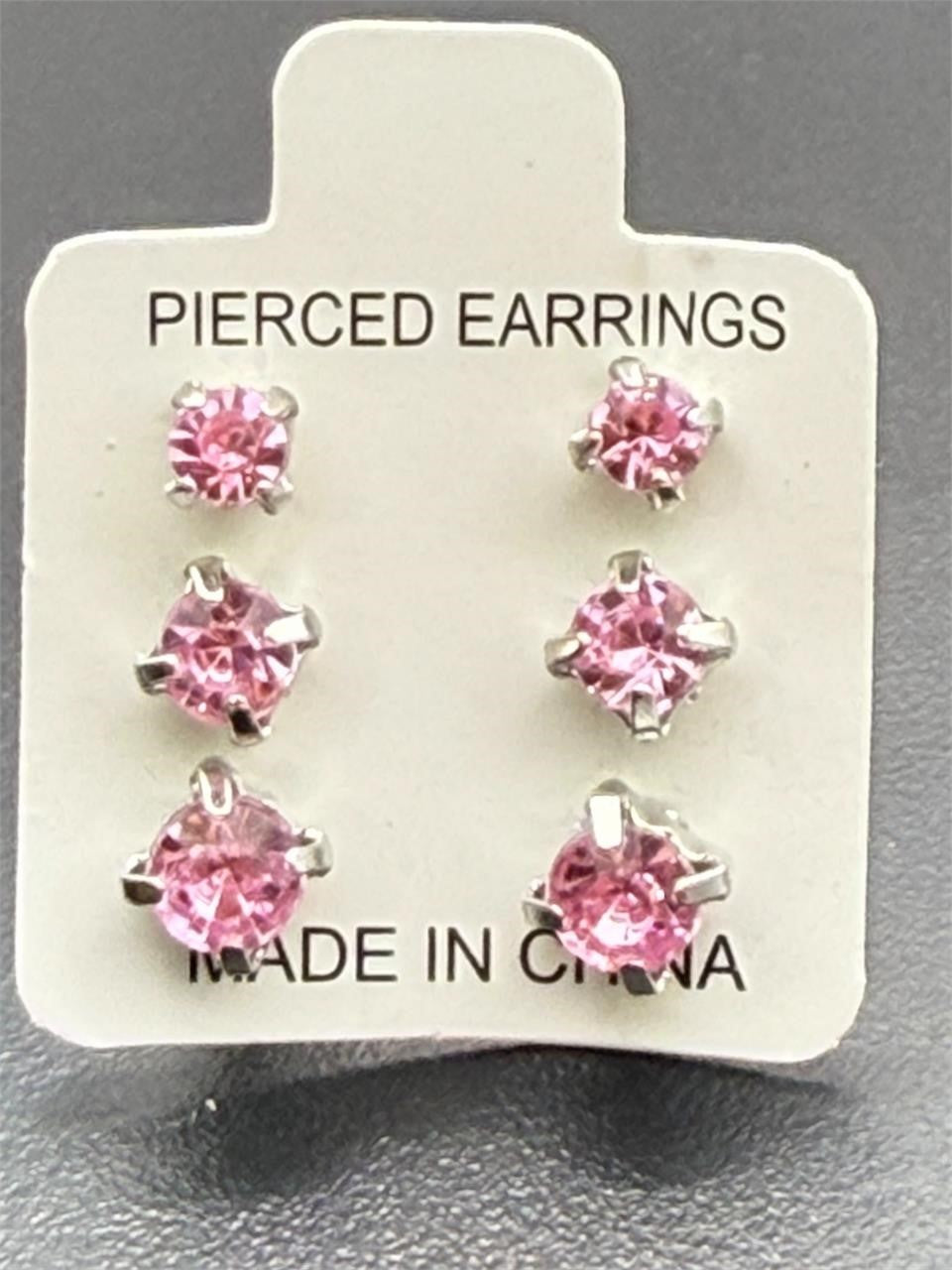Three pairs of pink crystal gem earrings in small, medium, and large sizes from Republic Mercantile displayed on a plain background.