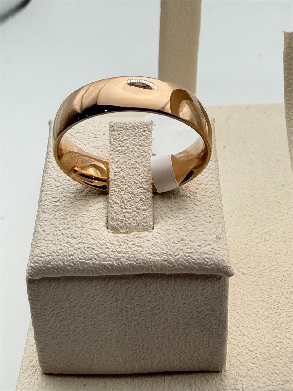 Men's rose gold stainless steel ring, size 12, featuring a sleek and shiny finish with a modern design.