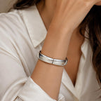 Large silver tone spring action bangle bracelet with smooth, shiny finish and open design, stylish accessory from Republic Mercantile.