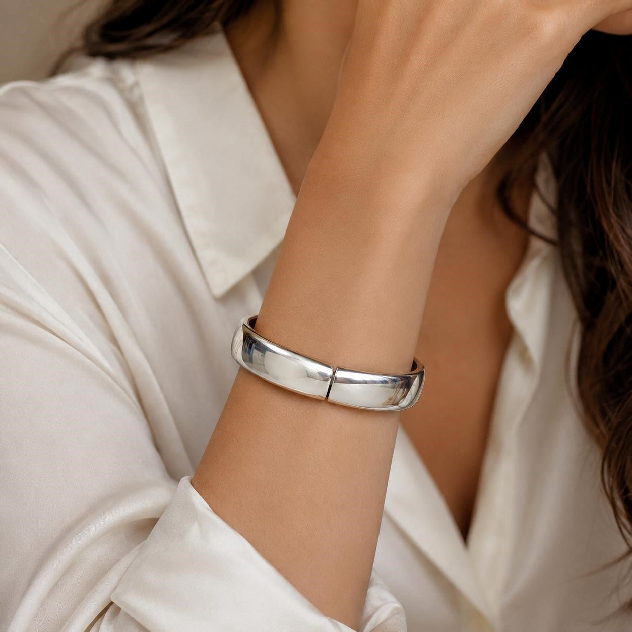 Large silver tone spring action bangle bracelet with smooth, shiny finish and open design, stylish accessory from Republic Mercantile.