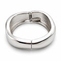 Silver tone large spring action bangle bracelet with a sleek, modern design, featuring smooth, shiny metal finish.