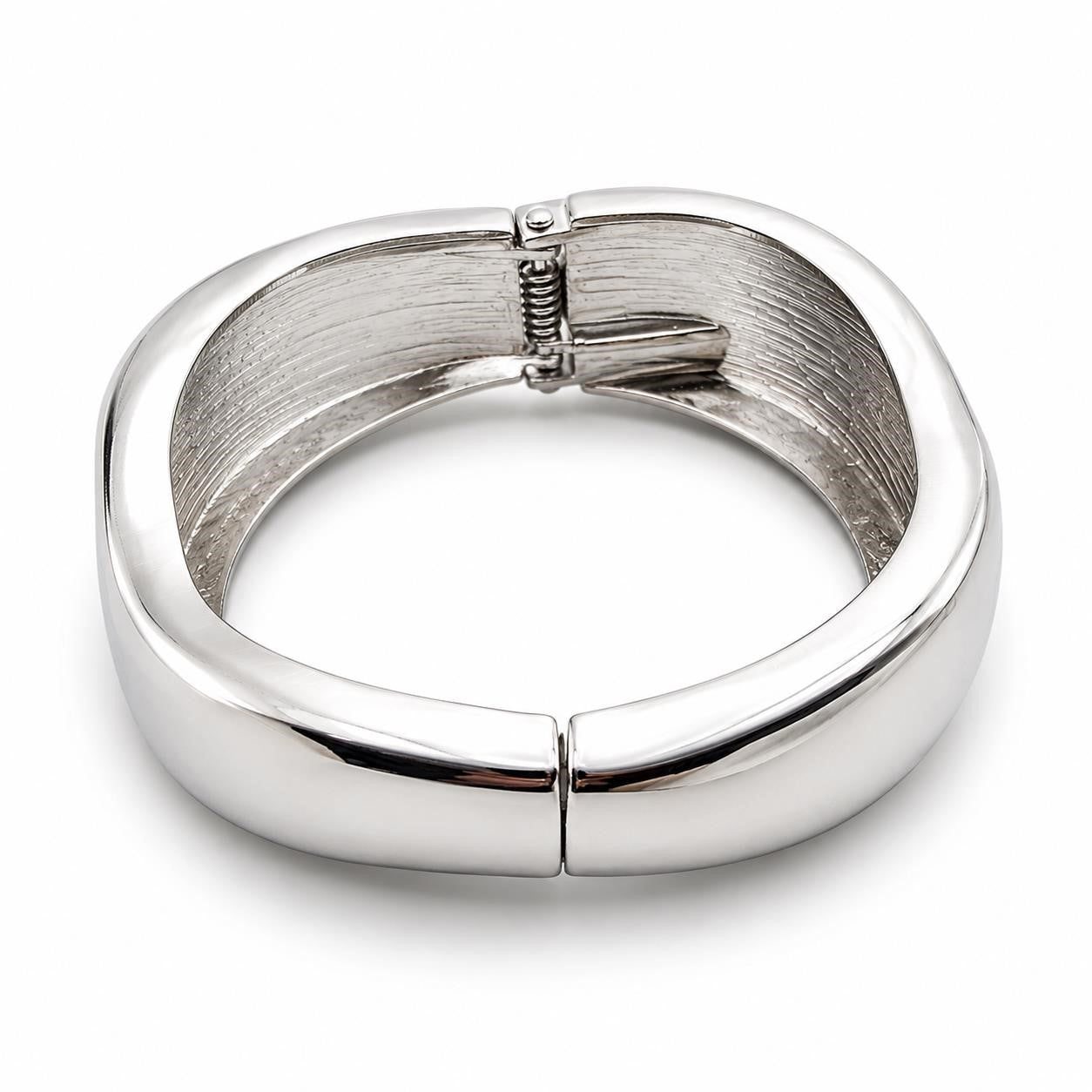 Silver tone large spring action bangle bracelet with a sleek, modern design, featuring smooth, shiny metal finish.