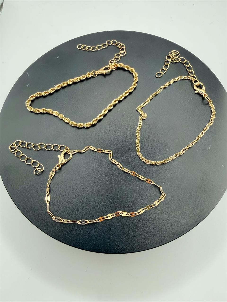 Set of 3 gold tone chain bracelets from Republic Mercantile featuring layered chain designs and adjustable clasps.