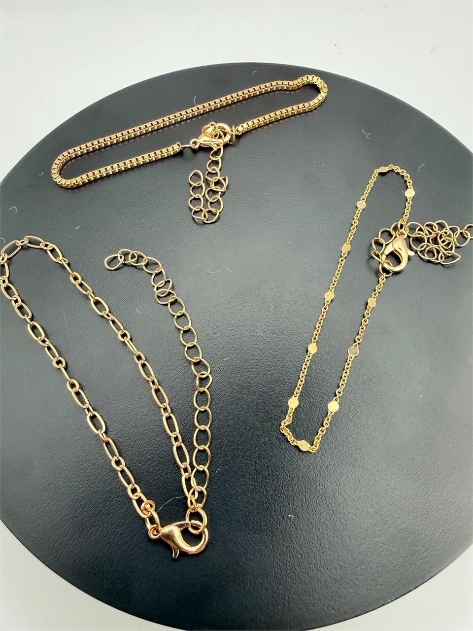 Set of three gold tone chain bracelets by Republic Mercantile featuring layered links and adjustable clasps.
