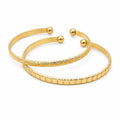 Two gold tone bangle bracelets from Republic Mercantile, featuring sleek and polished jewelry design for stylish accessories.